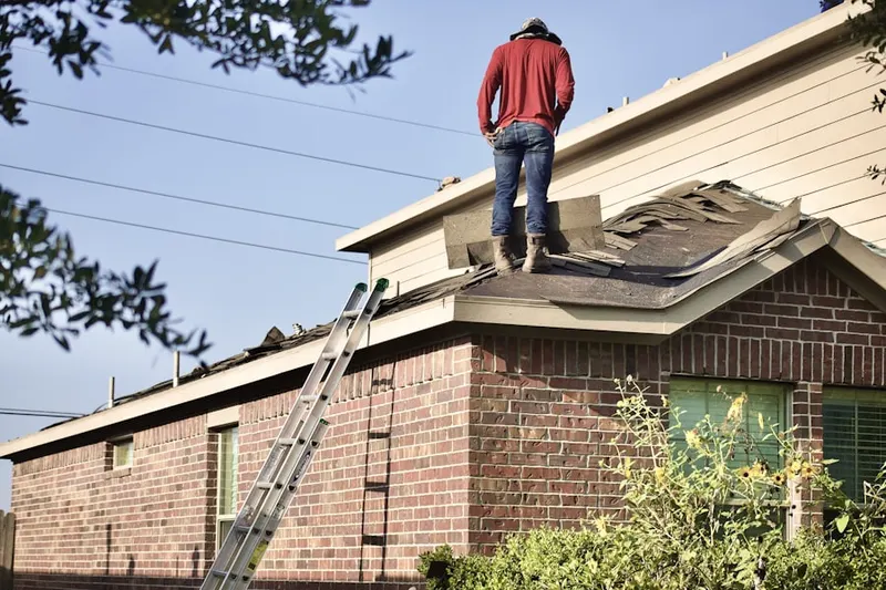 Professional roofer working on a residential roof in Hickory Acres